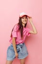 smiling woman pink t-shirts with cap on her head fashion summer style Royalty Free Stock Photo