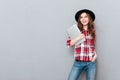 Smiling woman in plaid shirt holding laptop and looking away Royalty Free Stock Photo