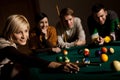 Smiling woman playing snooker Royalty Free Stock Photo