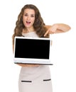 Smiling woman pointing on laptop blank screen Royalty Free Stock Photo