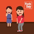 Smiling woman pointing a sad friend fools day celebration