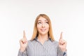 Smiling woman pointing up on background Royalty Free Stock Photo