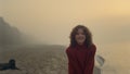 Smiling woman posing on beach at sunrise. Casual girl with happy face expression Royalty Free Stock Photo