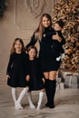 Smiling woman posing with her daughters and son on Christmas eve Royalty Free Stock Photo