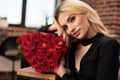 Smiling woman posing with red roses in heart shaped box Royalty Free Stock Photo