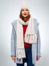 Smiling woman posing in wool winter coat wearing knitted hat and scarf Royalty Free Stock Photo