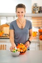 Smiling woman preparing halloween trick or treat candy for kids