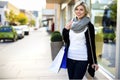 Smiling Woman With Purse And Shopping Bags Outside Store Royalty Free Stock Photo