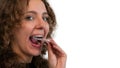 Smiling woman putting on her invisible silicone aligner for dental correction