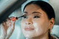 Smiling woman putting maskara on her eyelashes. Royalty Free Stock Photo