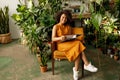 Smiling woman reading a book in her botanical workshop