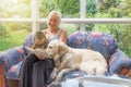 Smiling woman is reading a book together with pets Royalty Free Stock Photo