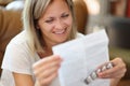 Smiling woman reading instructions for medical use of pills Royalty Free Stock Photo