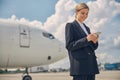 Smiling woman reading a text message on her cellphone Royalty Free Stock Photo