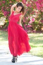 Smiling Woman in a red dress outside