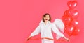 Smiling woman with red heart shaped balloons. Cute angel girl. Cute cupid in angelic wings. Royalty Free Stock Photo