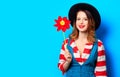 Smiling woman with red pinwheel Royalty Free Stock Photo