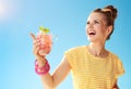 Smiling woman with refreshing cocktail pointing at something Royalty Free Stock Photo