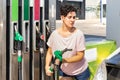 Smiling woman refueling her car in gas station Royalty Free Stock Photo