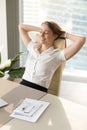 Smiling woman relaxing in office chair, relaxed at work, vertica Royalty Free Stock Photo