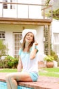 Smiling woman relaxing by pool Royalty Free Stock Photo