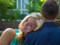 Smiling woman resting her head on the shoulder of a man under the sunlight Royalty Free Stock Photo