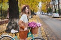 Smiling woman riding bicycle in centre city or autumn park. Royalty Free Stock Photo