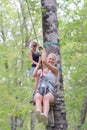 Smiling woman riding zip line in forest Royalty Free Stock Photo