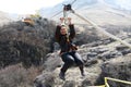 Smiling woman riding on zip line Royalty Free Stock Photo