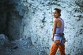 Smiling woman rock climber belayer with the rope