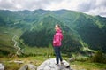 Smiling woman on rock in nature landscape with Transfagarashan Highway Royalty Free Stock Photo