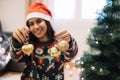 Smiling woman with Santa hat holding Christmas ornaments Royalty Free Stock Photo