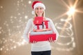 Smiling woman in santa hat holding stack of christmas gifts Royalty Free Stock Photo