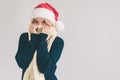 Smiling woman in Santa hat , isolated on white. The girl is dressed in sweater, christmas cap and scarf studio shot Royalty Free Stock Photo