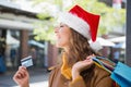 Smiling woman with santa hat and shopping bags Royalty Free Stock Photo