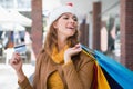Smiling woman with santa hat and shopping bags Royalty Free Stock Photo