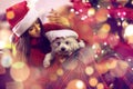 Smiling  woman in santa hats and  puppy.Christmas gift Royalty Free Stock Photo