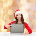 Smiling woman in santa helper hat with laptop Royalty Free Stock Photo