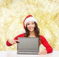 Smiling woman in santa helper hat with laptop Royalty Free Stock Photo