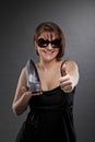 Smiling woman with shoe posing thumbs up Royalty Free Stock Photo