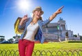 Smiling woman shopper at Piazza Venezia pointing at something