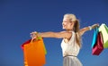 Smiling woman with shopping bag rising hands Royalty Free Stock Photo