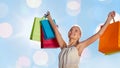 Smiling woman with shopping bag rising hands Royalty Free Stock Photo