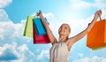 Smiling woman with shopping bag rising hands Royalty Free Stock Photo