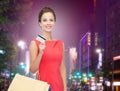 Smiling woman with shopping bags and credit card Royalty Free Stock Photo