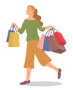 Smiling woman is standing with shopping bags. Young fashion girl picks up packages with clothes