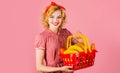 Smiling woman with shopping basket with groceries in Supermarket. Buying spree. Royalty Free Stock Photo