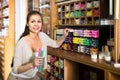 Smiling woman shopping multicolored candles