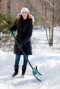 Smiling woman shoveling snow Royalty Free Stock Photo