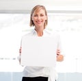 Smiling woman showing a big business card Royalty Free Stock Photo